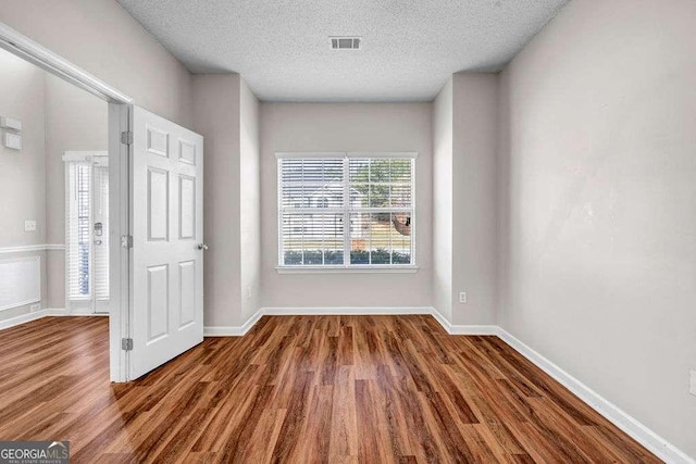 4970 Wewatta St SW, Atlanta, GA 30331 - unfurnished room with wood finished floors and a textured ceiling