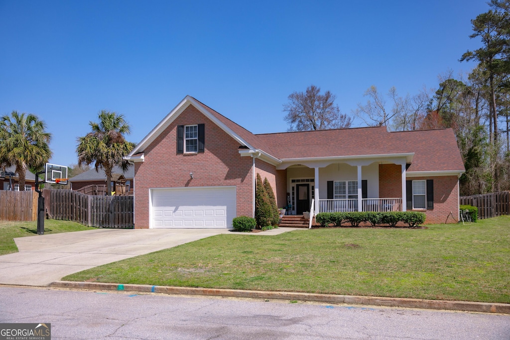 304 Farmington Dr W, Evans, GA 30809 - view of front of house featuring driveway, a front yard, fence, brick siding, and a porch