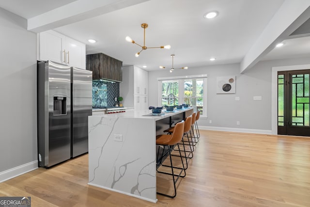 2672 Langland Ct NE, Atlanta, GA 30345 - kitchen featuring stainless steel fridge with ice dispenser, baseboards, light wood finished floors, white cabinets, and recessed lighting
