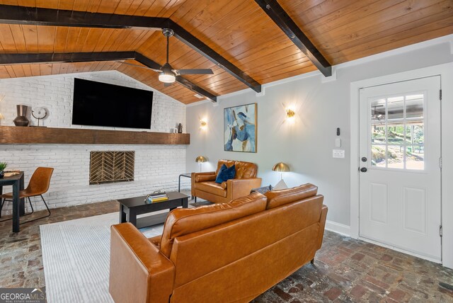 living area featuring a ceiling fan, wooden ceiling, and vaulted ceiling with beams