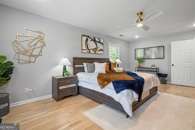 bedroom featuring recessed lighting, light wood-style flooring, a ceiling fan, and baseboards