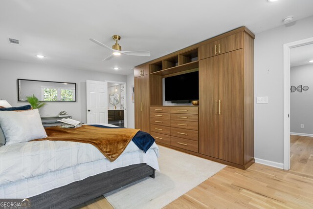 bedroom with light wood-style floors, baseboards, ensuite bath, visible vents, and recessed lighting