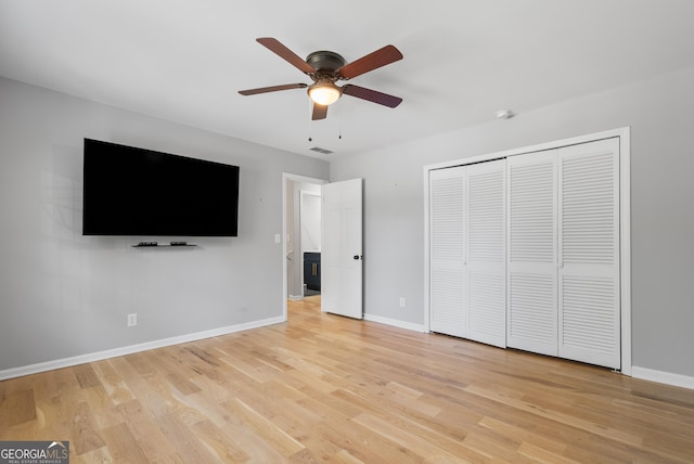 2672 Langland Ct NE, Atlanta, GA 30345 - unfurnished bedroom featuring light wood-type flooring, baseboards, a closet, and ceiling fan