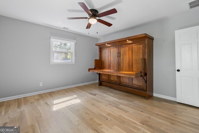 interior space featuring ceiling fan, baseboards, light wood-style floors, and visible vents