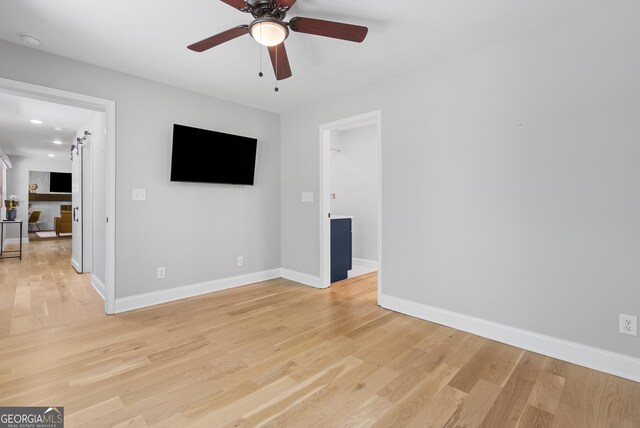spare room with light wood-style flooring, baseboards, and ceiling fan