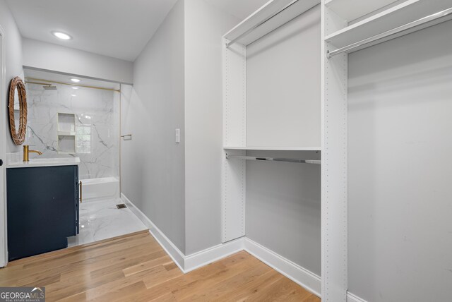 spacious closet featuring light wood finished floors