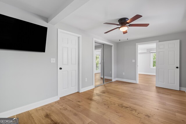 unfurnished bedroom featuring ceiling fan, baseboards, and light wood-style floors