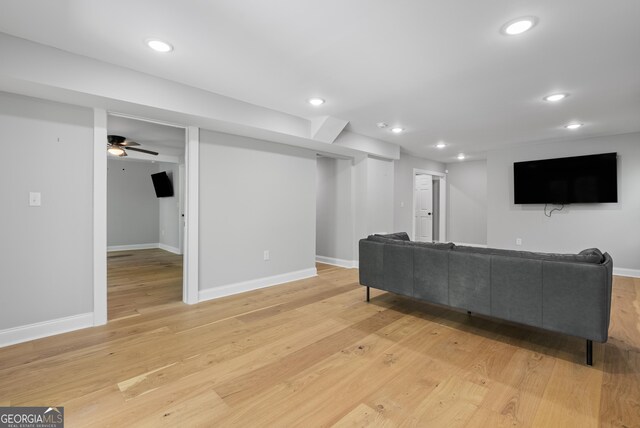 living area featuring light wood-type flooring and baseboards