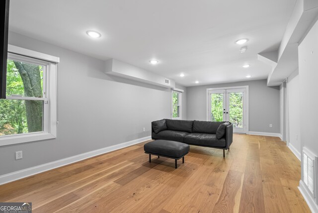 2672 Langland Ct NE, Atlanta, GA 30345 - living room featuring baseboards, light wood-style flooring, healthy amount of natural light, recessed lighting, and french doors