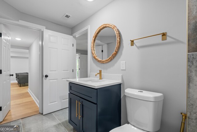 bathroom featuring visible vents, tile patterned floors, vanity, and toilet