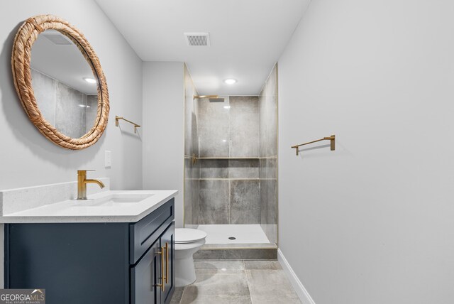bathroom featuring toilet, baseboards, visible vents, a shower stall, and vanity