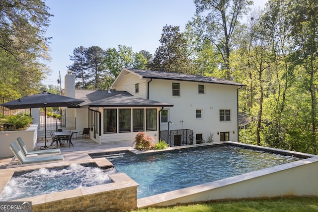 2672 Langland Ct NE, Atlanta, GA 30345 - rear view of property featuring a sunroom, a chimney, an outdoor pool, a shingled roof, and a patio