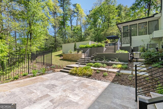 view of yard with fence, stairs, and a patio