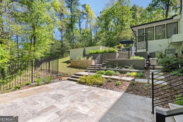2672 Langland Ct NE, Atlanta, GA 30345 - view of patio / terrace featuring stairs, fence, and view of scattered trees