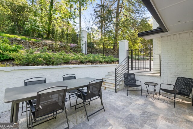 view of patio / terrace with outdoor dining space and fence