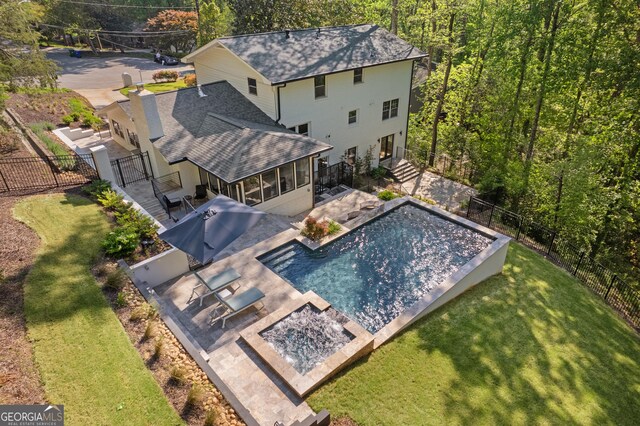 view of pool featuring a fenced in pool, a sunroom, a fenced backyard, and a lawn