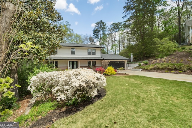 2672 Langland Ct NE, Atlanta, GA 30345 - view of front facade with french doors, an attached garage, driveway, and a front yard
