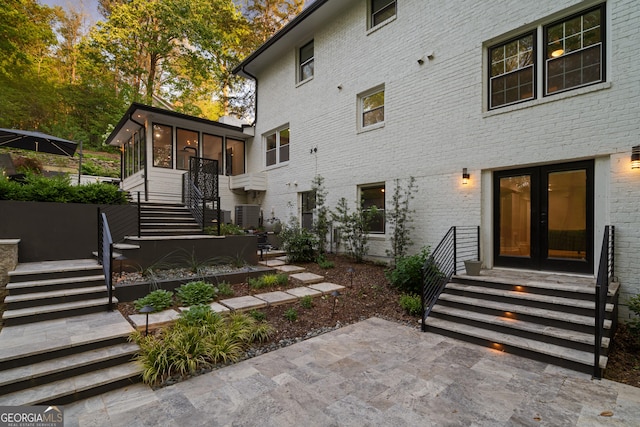 2672 Langland Ct NE, Atlanta, GA 30345 - rear view of house with stairway, a sunroom, french doors, central AC, and a patio area