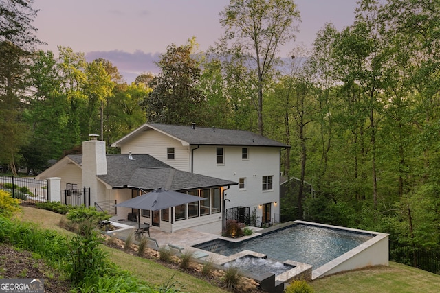 2672 Langland Ct NE, Atlanta, GA 30345 - rear view of property featuring a sunroom, an outdoor pool, fence, a patio, and roof with shingles