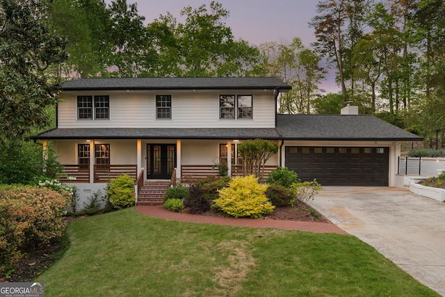 2672 Langland Ct NE, Atlanta, GA 30345 - view of front of house with driveway, a garage, a front yard, a chimney, and a porch