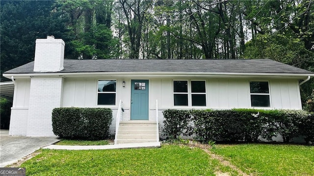 810 Commodore Dr NW, Atlanta, GA 30318 - ranch-style home with a chimney, board and batten siding, a front yard, and concrete driveway