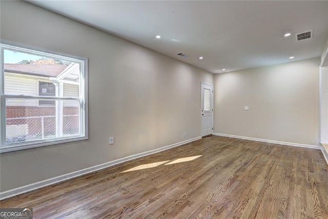 810 Commodore Dr NW, Atlanta, GA 30318 - empty room with wood finished floors, baseboards, and recessed lighting