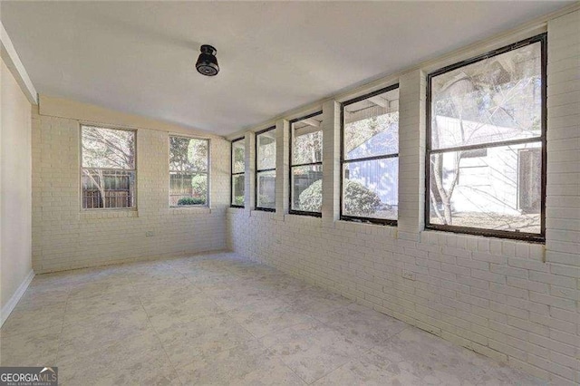 810 Commodore Dr NW, Atlanta, GA 30318 - unfurnished sunroom with brick wall