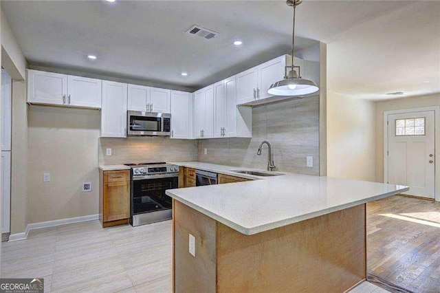 810 Commodore Dr NW, Atlanta, GA 30318 - kitchen featuring stainless steel appliances, a sink, light countertops, backsplash, and recessed lighting