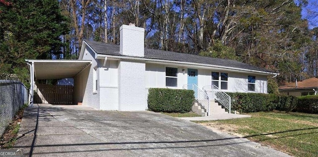 810 Commodore Dr NW, Atlanta, GA 30318 - view of front facade with a chimney, driveway, a carport, and brick siding