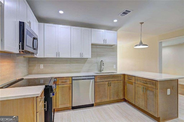 810 Commodore Dr NW, Atlanta, GA 30318 - kitchen with dishwasher, a sink, electric range, a peninsula, and light countertops