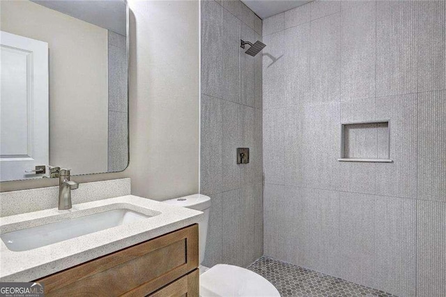 810 Commodore Dr NW, Atlanta, GA 30318 - full bathroom featuring toilet, a tile shower, and vanity