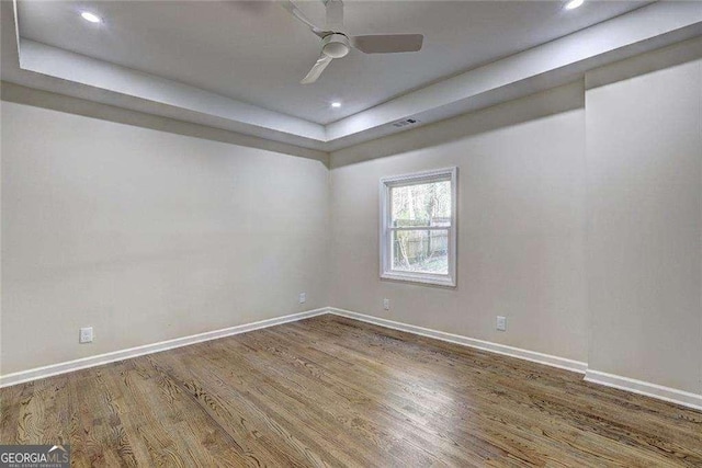 810 Commodore Dr NW, Atlanta, GA 30318 - unfurnished room featuring a raised ceiling, wood finished floors, baseboards, recessed lighting, and a ceiling fan