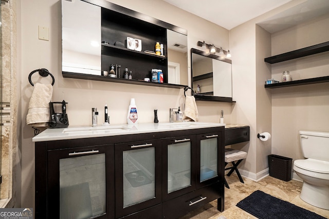 3501 Roswell Rd NE Unit 211, Atlanta, GA 30305 - bathroom with toilet, double vanity, and baseboards