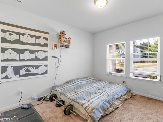 bedroom featuring baseboards and carpet floors