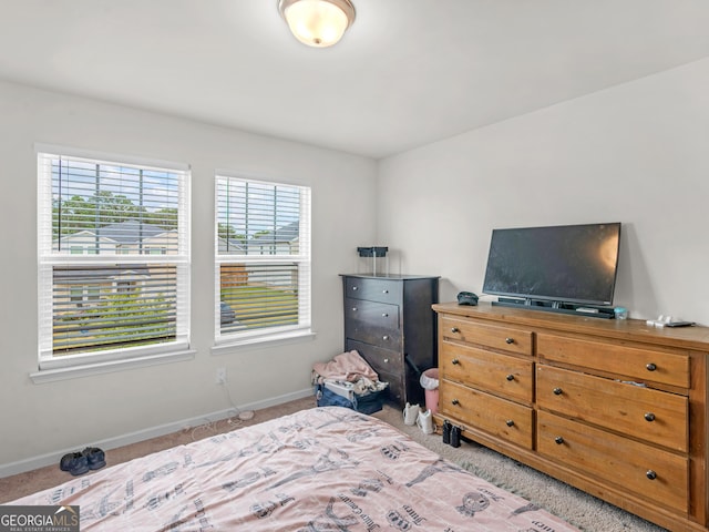 bedroom featuring baseboards and carpet