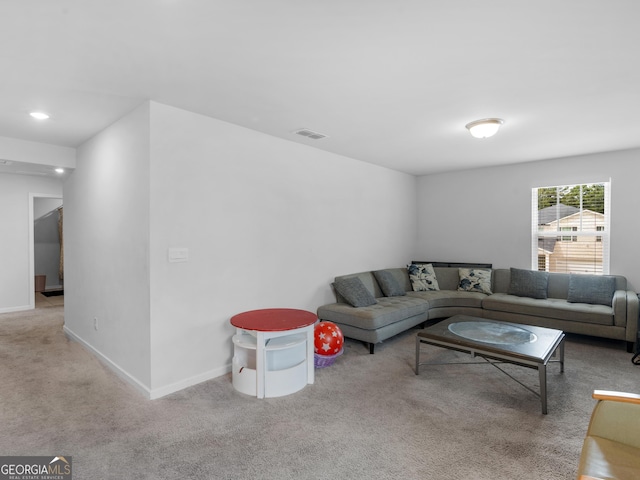 carpeted living area featuring baseboards and visible vents