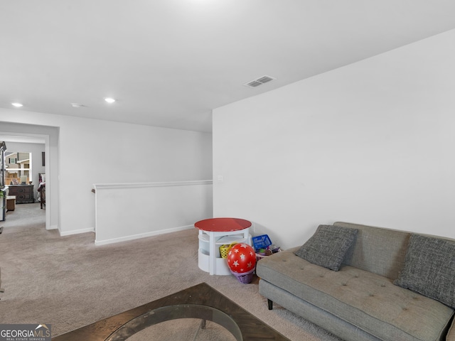 carpeted living room featuring baseboards, visible vents, and recessed lighting