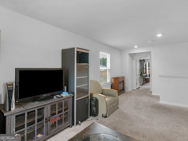 living room featuring carpet floors, baseboards, and recessed lighting