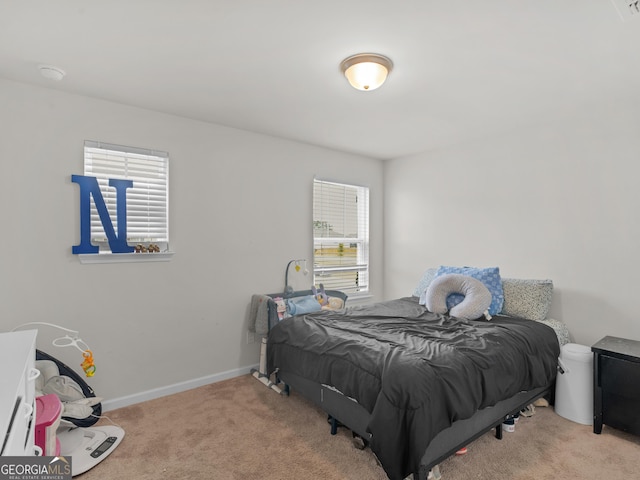 carpeted bedroom featuring baseboards