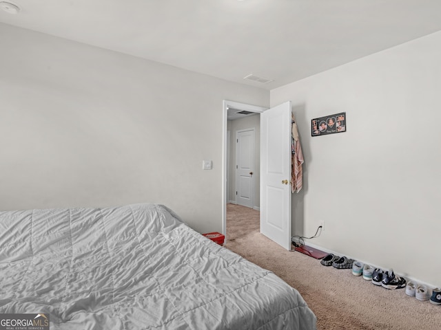 carpeted bedroom with baseboards and visible vents