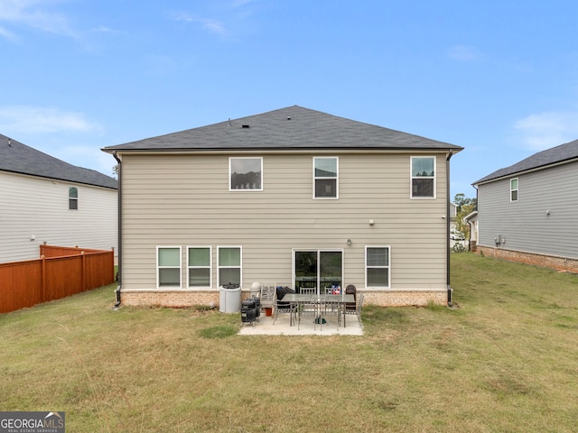 rear view of house featuring fence, a lawn, and a patio