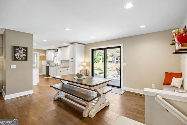 dining room with baseboards, visible vents, wood finished floors, and recessed lighting