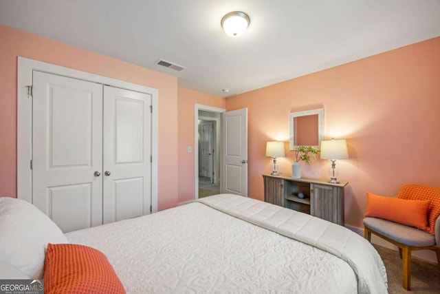 bedroom with a closet, carpet flooring, and visible vents