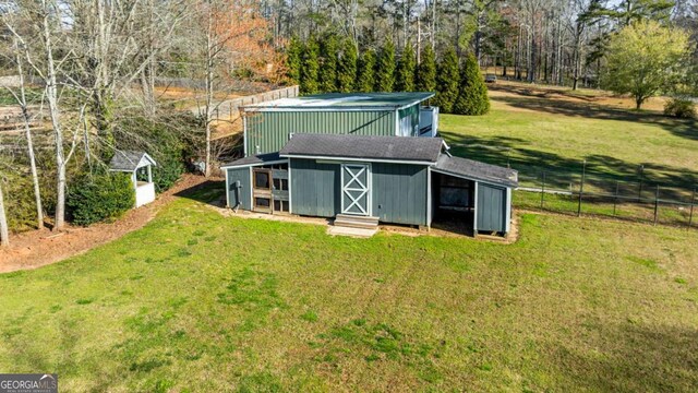 view of outdoor structure with an outbuilding and fence
