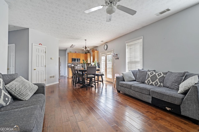 85 Clairidge Ln, Lawrenceville, GA 30046 - living area featuring ceiling fan with notable chandelier, dark wood-type flooring, a textured ceiling, and visible vents