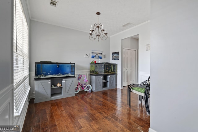 85 Clairidge Ln, Lawrenceville, GA 30046 - interior space featuring a wainscoted wall, visible vents, an inviting chandelier, and wood-type flooring