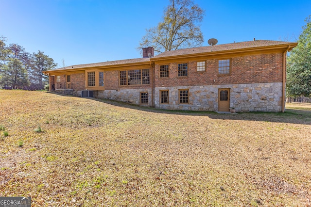 9095 Cedar Grove Rd, Fairburn, GA 30213 - rear view of property with stone siding, brick siding, a yard, and a chimney
