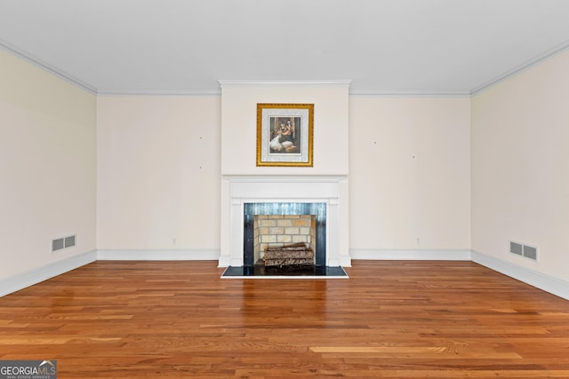 9095 Cedar Grove Rd, Fairburn, GA 30213 - unfurnished living room with a fireplace, ornamental molding, visible vents, and wood finished floors