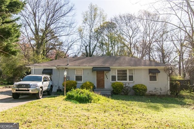 ranch-style house with brick siding, a front yard, and driveway