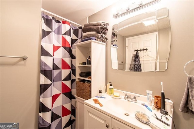 bathroom with a shower with shower curtain and vanity